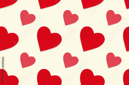 Red heart seamless pattern. Felt texture decorative hearts on pastel cream background