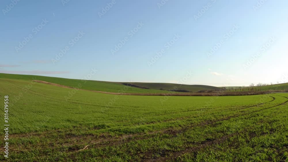 Timelapse of moving clouds and grass in the Moravian Tuscany region during a sunny day with strong wind on a freshly planted field full of greenery. Timelapse of moving clouds and grass in the Moravian Tuscany region during a sunny day with strong wind on a freshly planted field full of greenery.