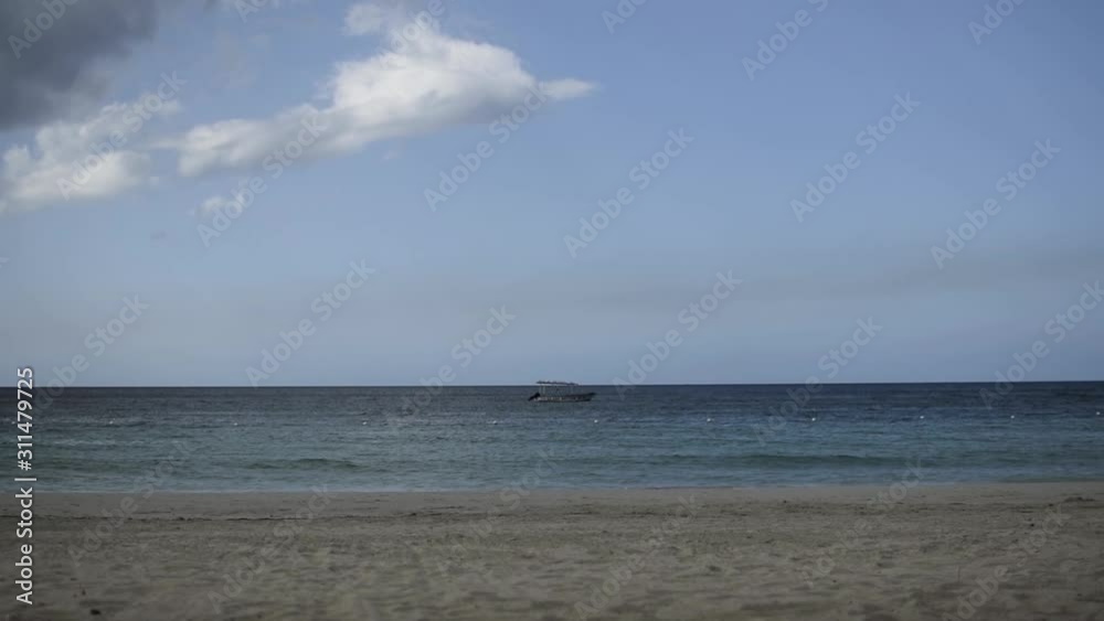 Beach with a single Boat in the background