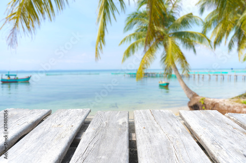 empty wooden table on the blurred background of the beach