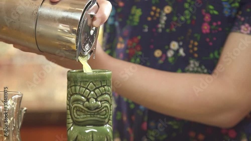 Pouring Yellow Liquid into a Tiki Glass - Close Up 