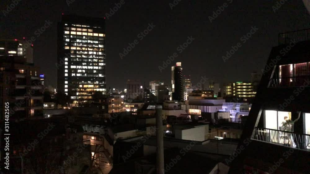 TOKYO, JAPAN - February 5, 2019: Photo of Japan apartment buildings and homes at night. Japan hosts 2020 Olympics. TOKYO, JAPAN - February 5, 2019: Photo of Japan apartment buildings and homes at night. Japan hosts 2020 Olympics.