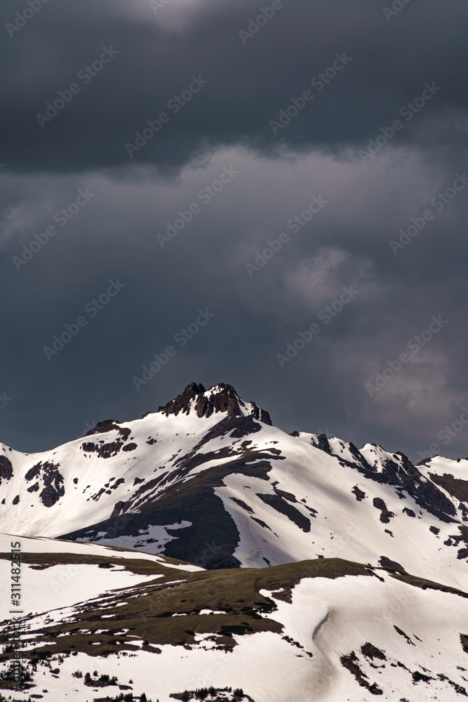 Snowy mountains peaks with dark clouds in the background. Loveland Pass, Colorado