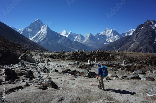 Everest trek, Man hiking in Himalayas with view of Ama Dablam mountain. Sagarmatha national park, Solukhumbu, Nepal