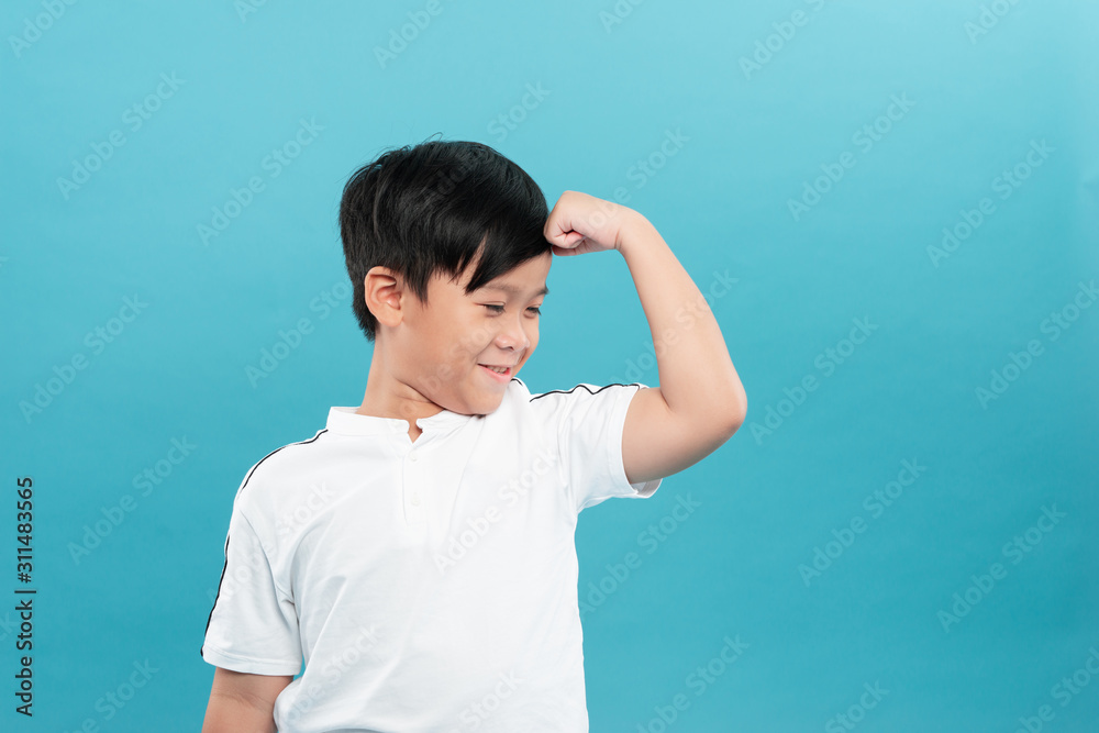 Child. Funny Little Boy.Sport Handsome Boy. Strong. bodybuilder. showing his hand biceps muscles Child. Funny Little Boy.Sport Handsome Boy. Strong. bodybuilder. showing his hand biceps muscles