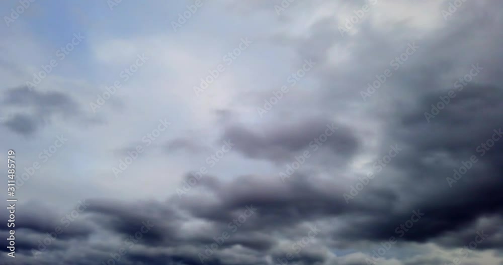 Dramatic storm dark rainy clouds moving over the sky. Stormy and rainy weather. Timelapse 4K footage