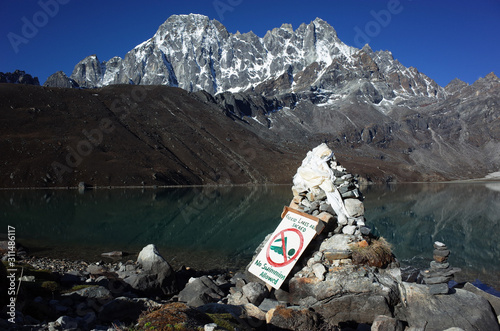 No swimming sign on high altitude sacred Gokyo lake. Hiking in Nepal Himalayas photo