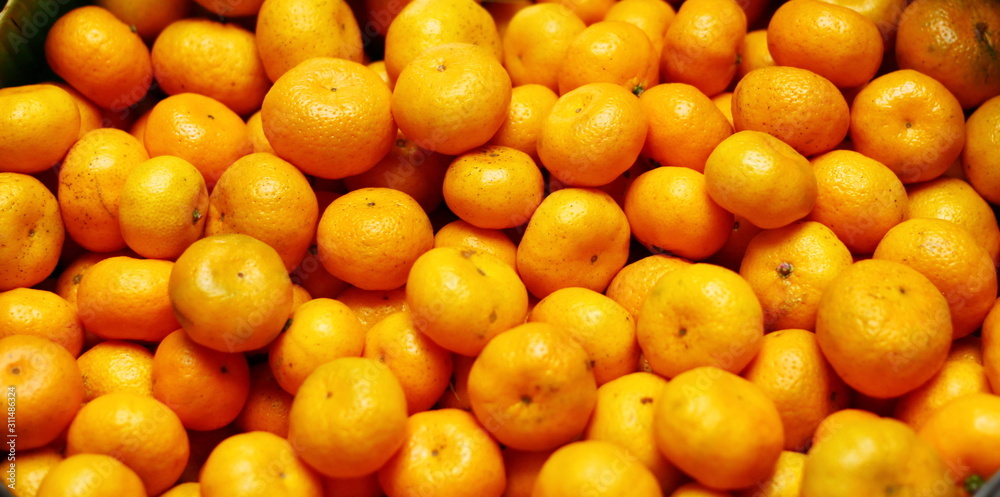 Fresh yellow oranges in the basket