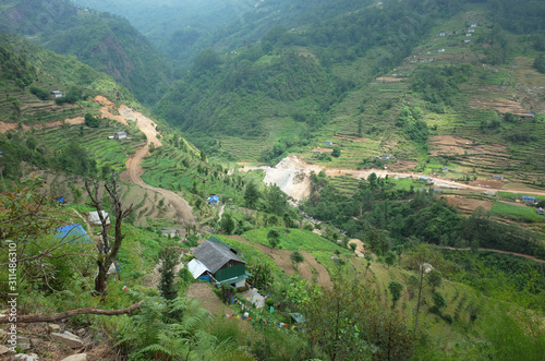 New road and house in Kharikhola village in Himalaya mountains, Solukhumbu region, Nepal photo