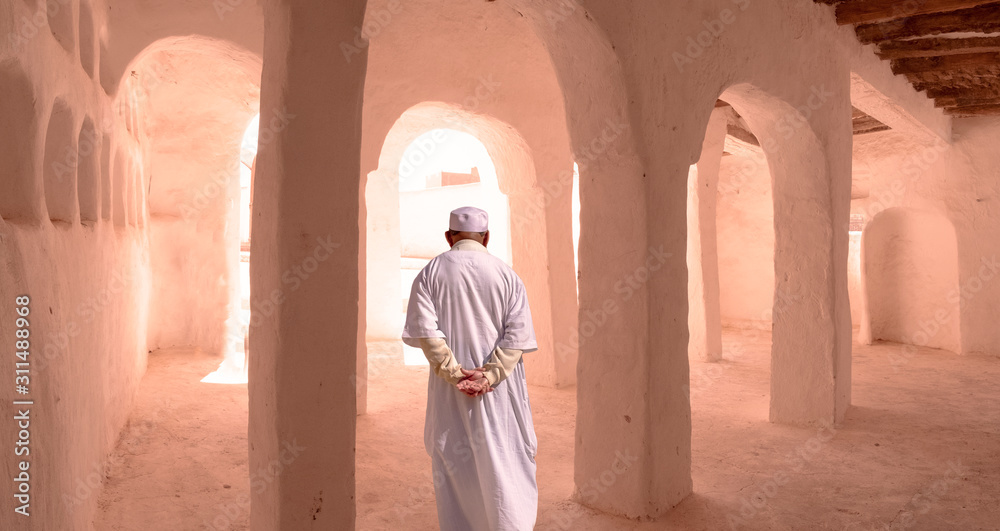 Muslim man meditating in the mystic atmosphere in Mosque at El Atteuf, Algeria