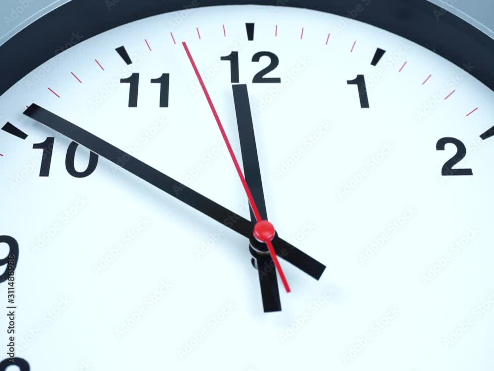 Twelve o'clock White wall clock on White background, the second hand moves slowly, Time concept. Twelve o'clock White wall clock on White background, the second hand moves slowly, Time concept.