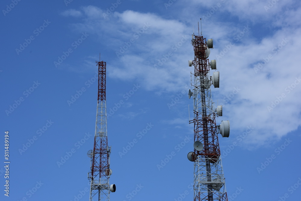 .Wireless Communication Antenna With bright sky.Telecommunication tower with antennas.High pole for signal transmission. .Wireless Communication Antenna With bright sky.Telecommunication tower with antennas.High pole for signal transmission.