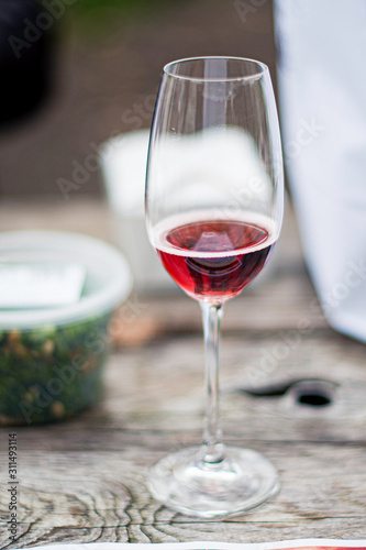 A close up of sparkling Rosé wine glass on a picnic table