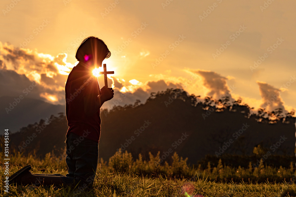 Silhouette of woman praying with cross in nature sunrise background ...