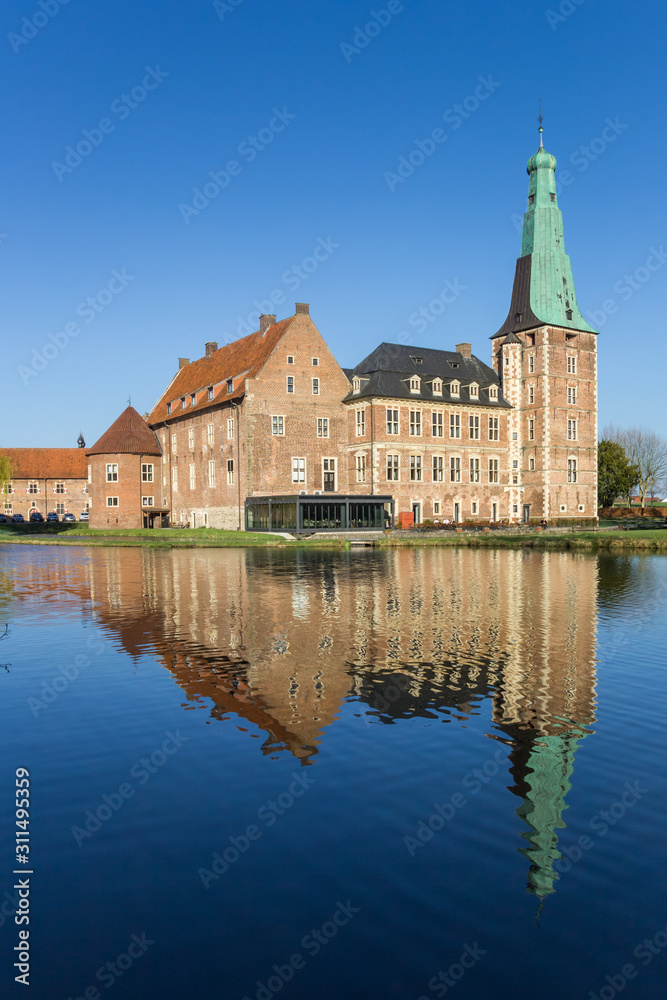 Castle Raesfeld with reflection in the water in Germany