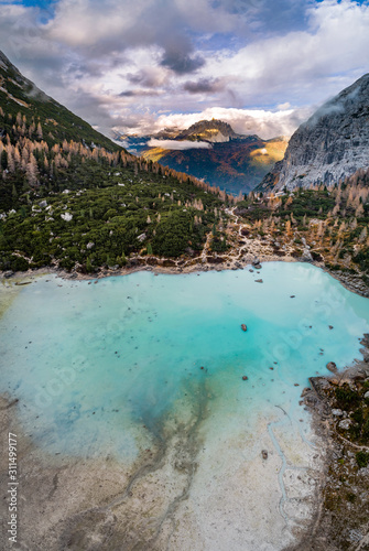 Frozen Turquoise colour Lake Sorapis in italian Alps / Lago di Sorapiss / Captured from above with a drone photo