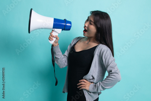 Beautiful young Asian woman announce with megaphone.