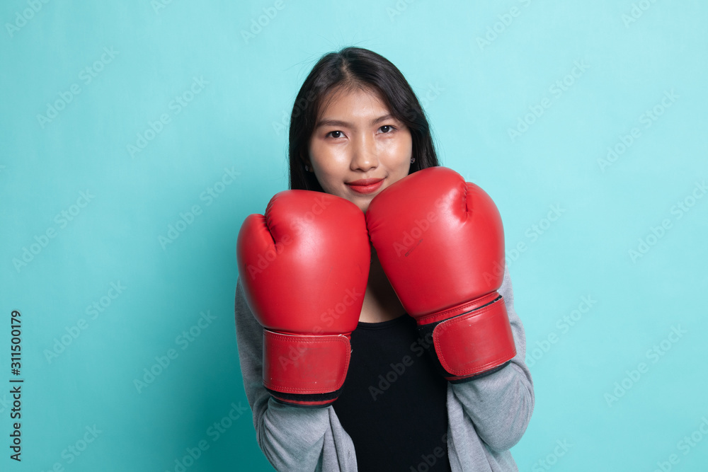 Young Asian woman with red boxing gloves. Young Asian woman with red boxing gloves.