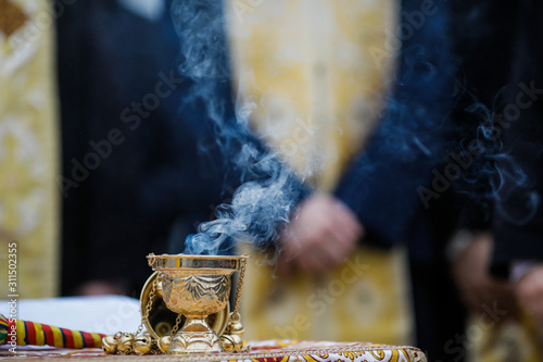 Obraz na plátně Details with a golden metallic christian orthodox frankincense burner, or censer
