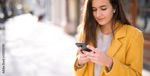 Portrait of a beautiful woman using a mobile