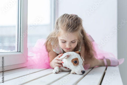 Pet and children concept - Child with dog Jack Russell Terrier at home