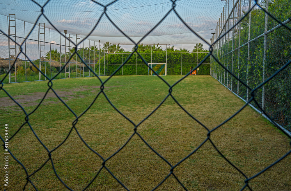 Fenced soccer fiels or handball field with lights