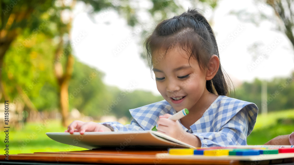 Happy girl drawing at park. Happy girl drawing at park.