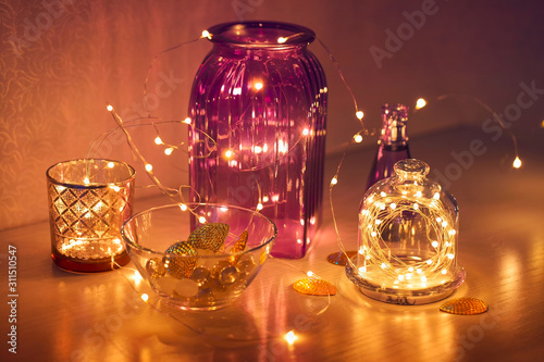 Twinkling lights in the interior, festive garlands with glass vases, home cozy decor