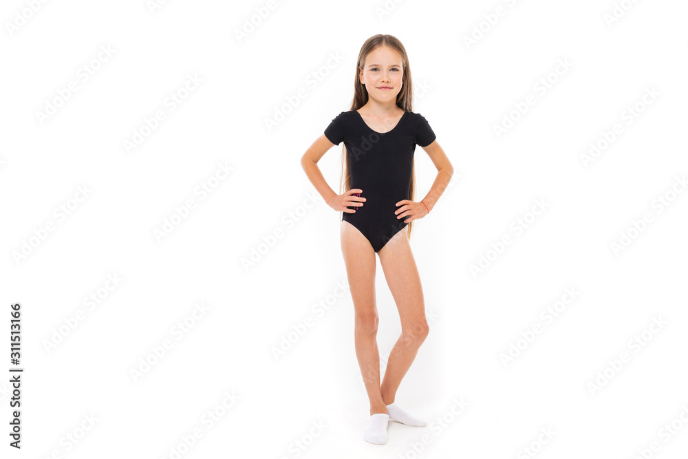 young gymnast in a black sports swimsuit on a white background with copy space