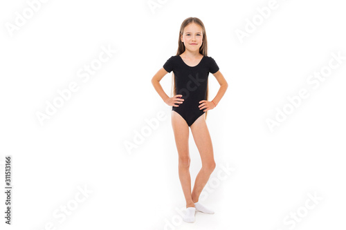 young gymnast in a black sports swimsuit on a white background with copy space