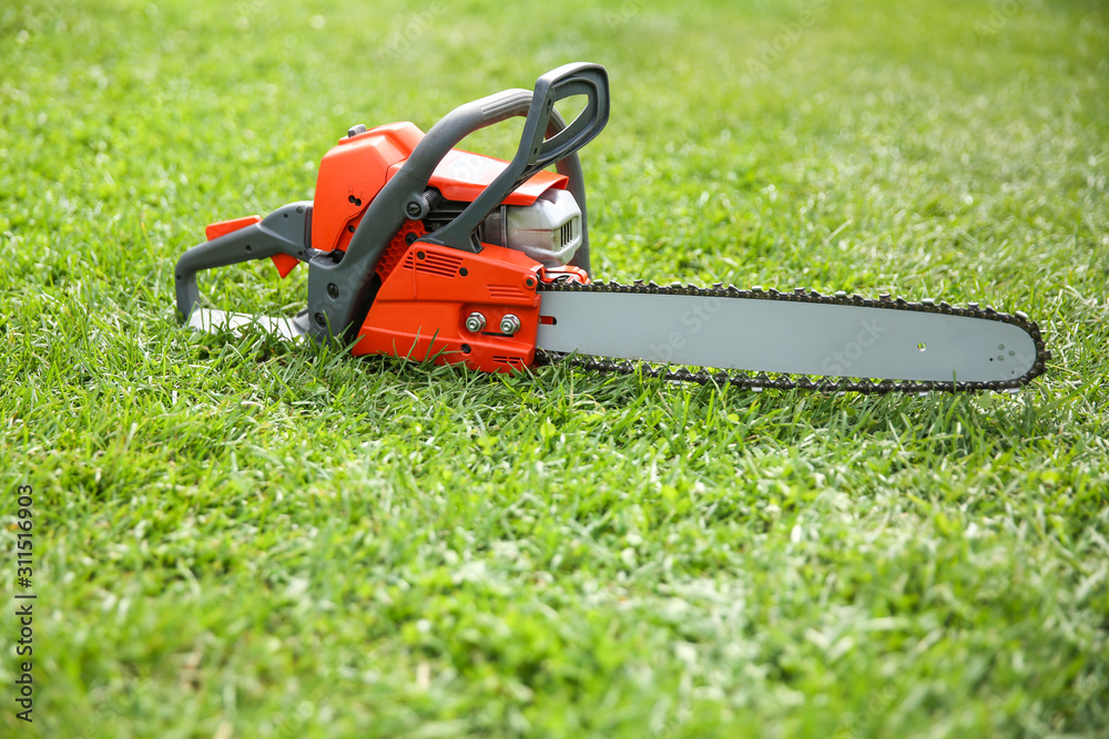 chainsaw on grass close up with copy space
