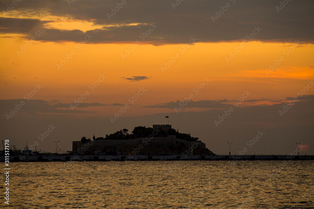 Kusadasi, Turkey - September 17, 2019: View of the coast of Kusadasi, Turkey. Sunset over the port in the tourist town.