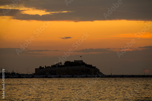 Kusadasi, Turkey - September 17, 2019: View of the coast of Kusadasi, Turkey. Sunset over the port in the tourist town.