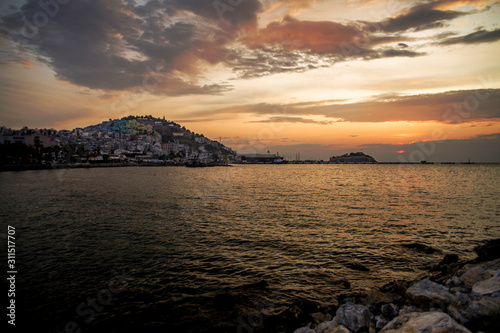 Kusadasi, Turkey - September 17, 2019: View of the coast of Kusadasi, Turkey. Sunset over the port in the tourist town.