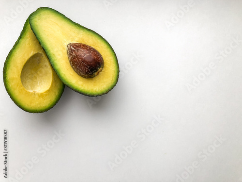 Cut ripe avocado. Isolated on a white background.
