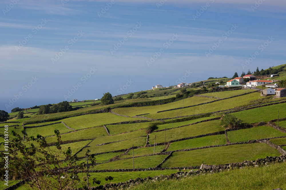 Green meadows and houses of Terceira island. One of the Azores is located in the Atlantic Ocean.
