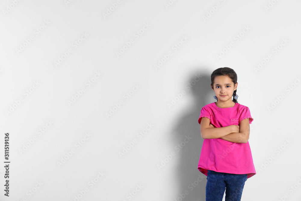 Portrait of cute little girl on light background, space for text Portrait of cute little girl on light background, space for text