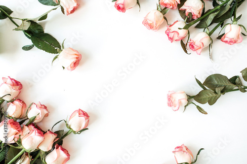 Round frame border of pink rose flowers on white background. Mockup blank copy space. Flat lay, top view floral composition.