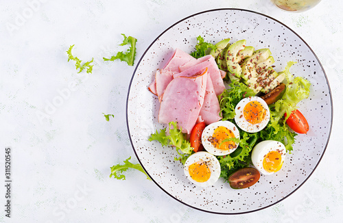 Ketogenic/paleo diet. Boiled eggs, ham, avocado and fresh salad.  Keto breakfast. Brunch.  Top view, overhead photo