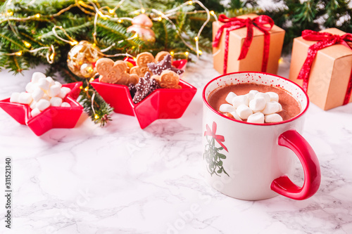 Hot chocolate with marshmallow and cookies in Xmas setting background. Concept of Christmas holiday. Warm tone. Horizontal photo