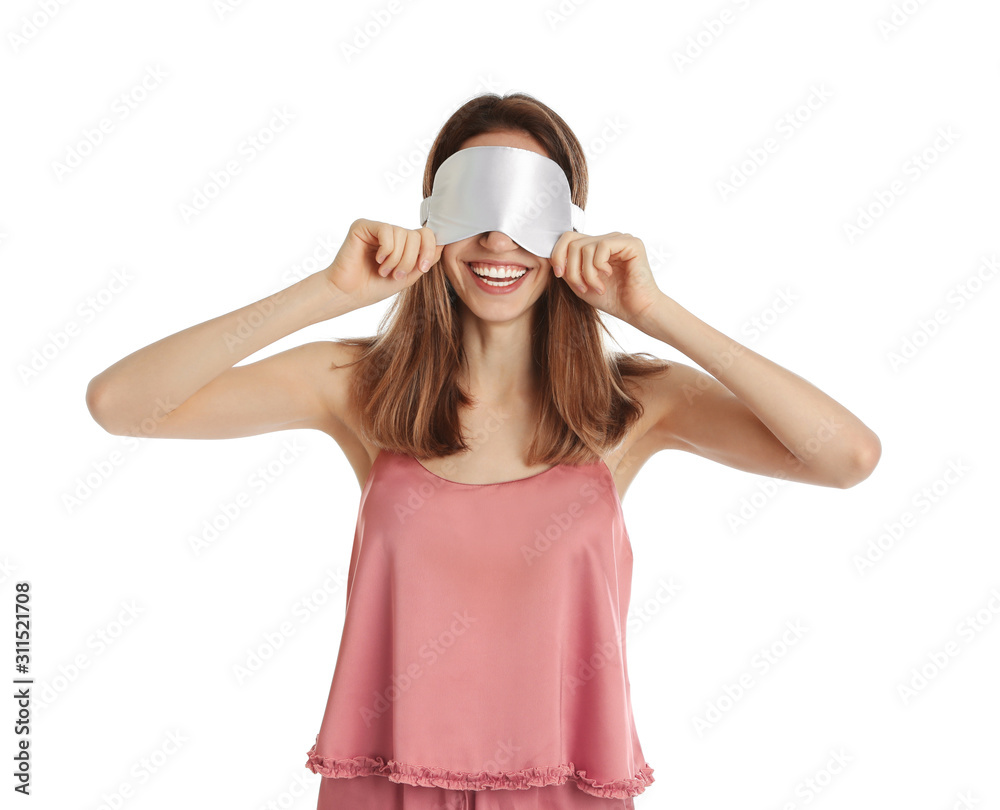 Beautiful woman wearing pajamas and sleep mask on white background. Bedtime