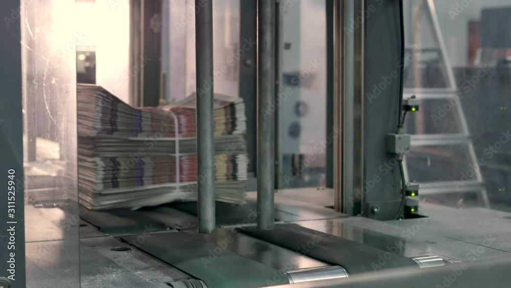 Binding newspapers in a printing factory Binding newspapers in a printing factory