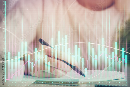 Forex chart displayed on woman's hand taking notes background. Concept of research. Multi exposure © peshkova