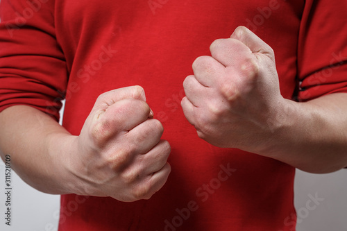 the man's clenched fists