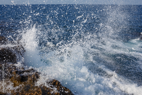 Sea wave breaks on a rocky shore