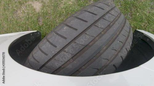 Above view of a wheel of a car while changing the driving direction on agrass surface. The environmental sound is present. photo