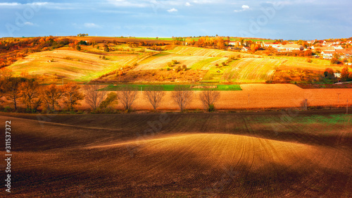 Beautiful rural landscape with agricultural fields and small village, traditional countryside of Moravia region, Czech Republic