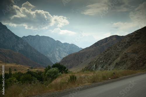 Road on the way from Bishkek to Osh with beautiful mountain range in Kyrgyzstan