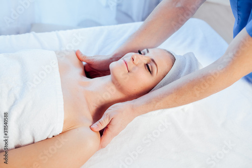 doctor cosmetologist doing facial massage girl spa