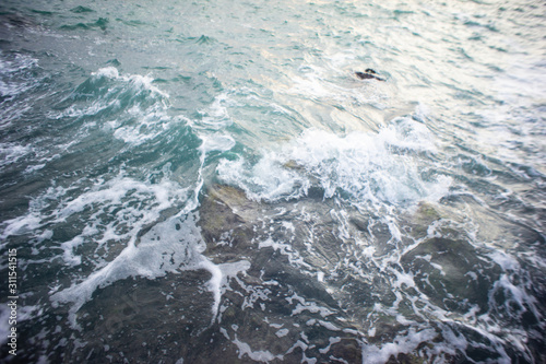 Sea waves are breaking on stones. Sea foam © Khoroshilov Evgeniy